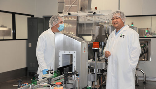 President and CEO Steven Dai reviews IVC lab equipment with technician